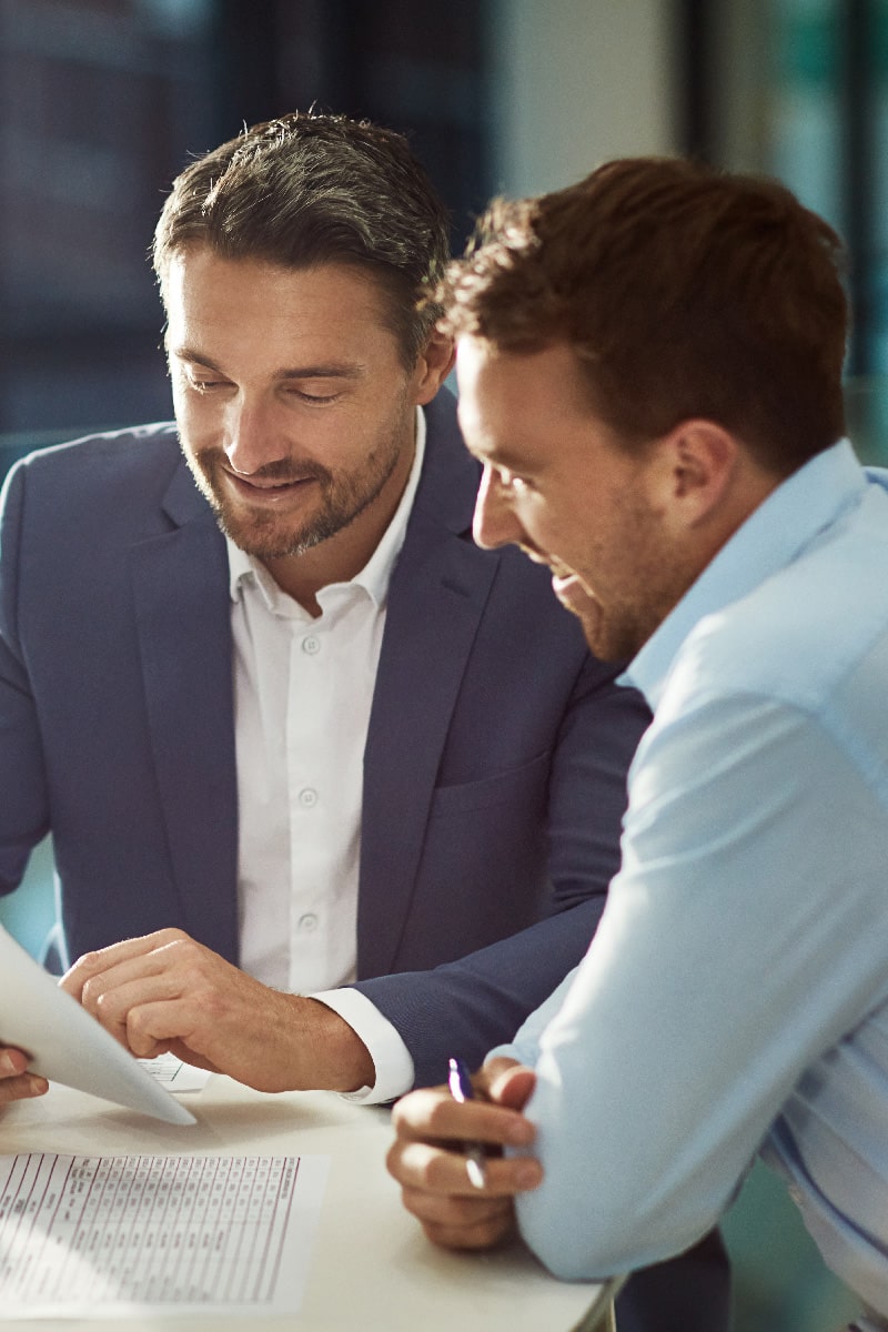 Two office workers looking at document