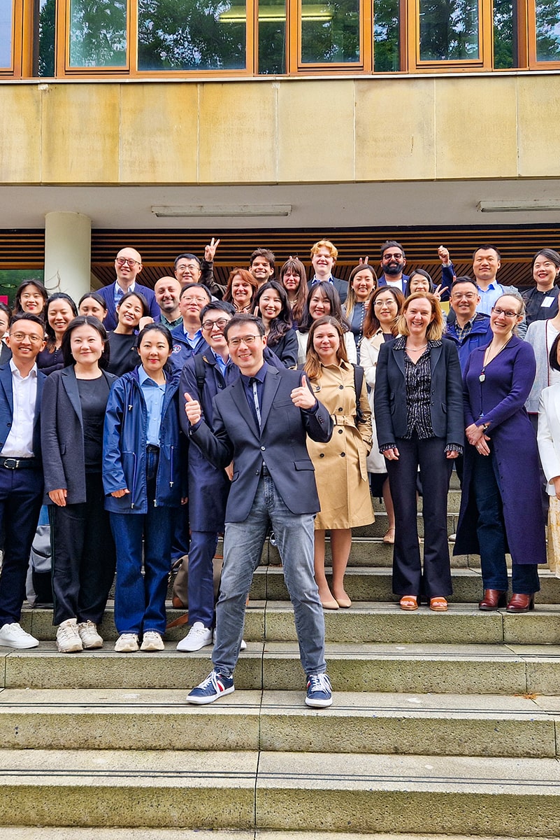 Group of around 30 participants on the Rainforest Foundation Norway executive education programme, standing on the steps of the Business School