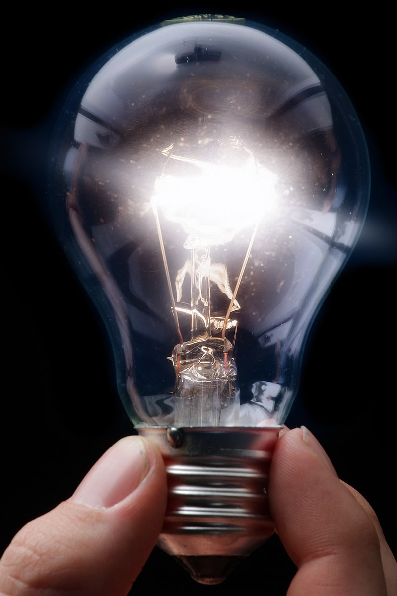 Hand holding lightbulb