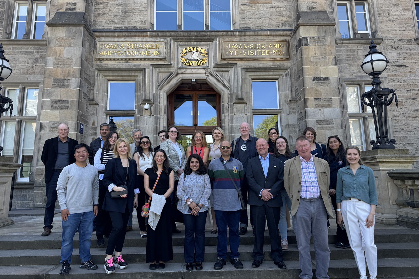 Attendees stand at the entrance of the recently renovated Old Infirmary building, ahead of a guided tour of the Edinburgh Futures Institute
