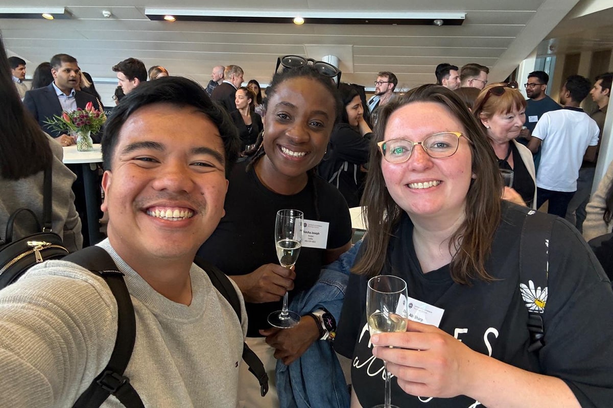 Nial takes a selfie with two fellow Global Alumni Day 2025 attendees