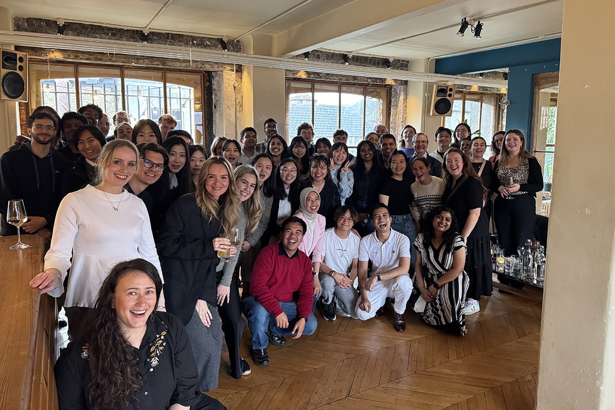Large group of students standing at a bar