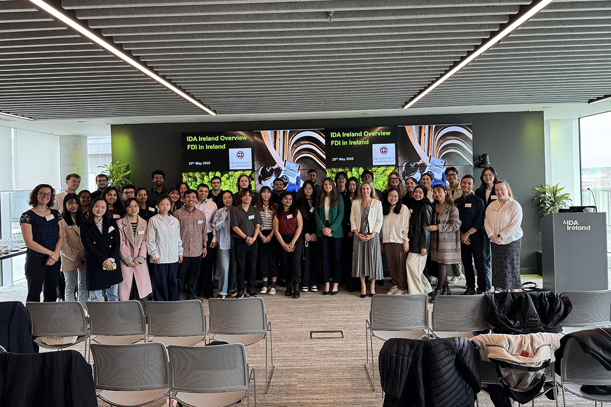Large group of students standing on a stage at a presentation