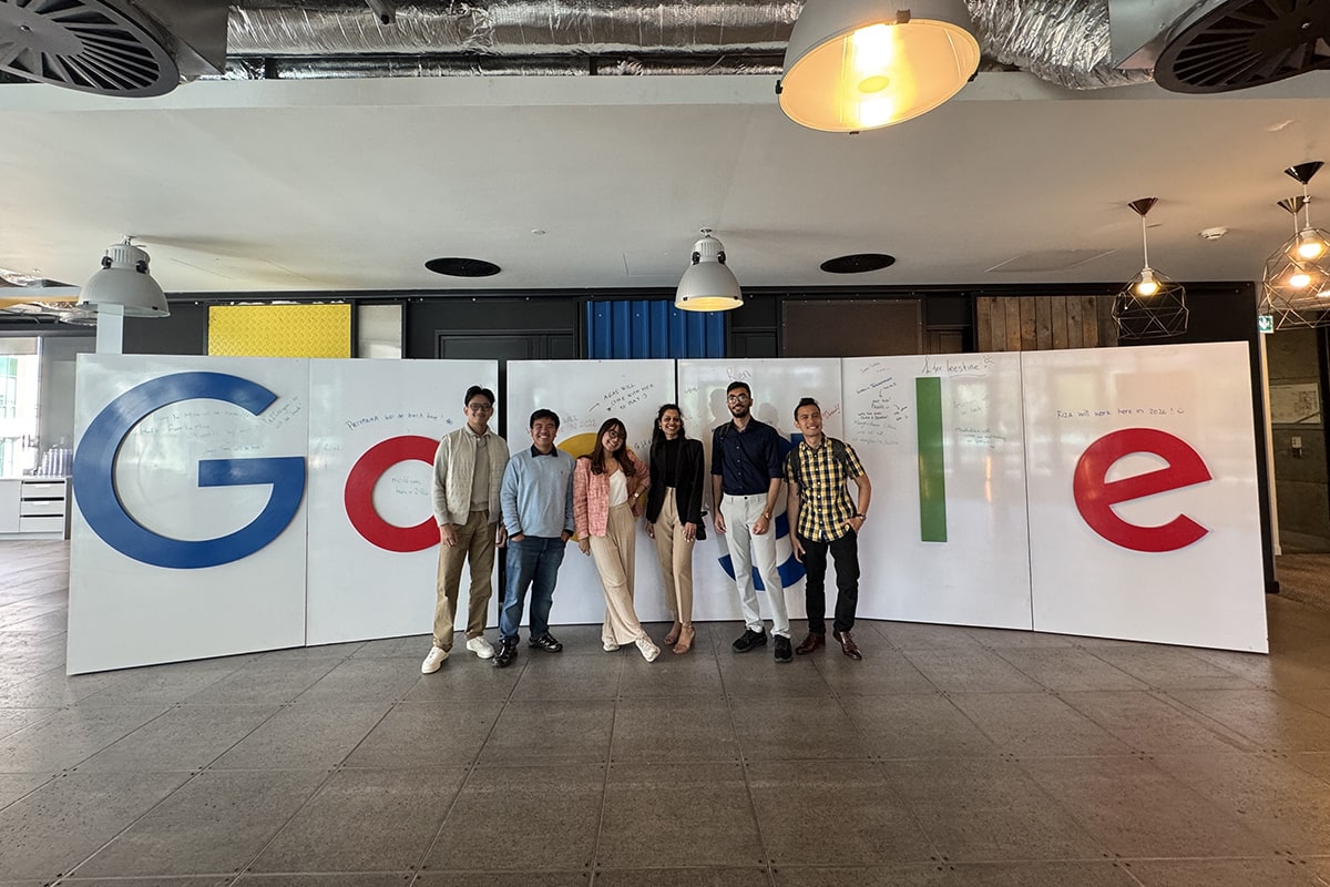 Group of students standing in front of a large Google sign inside Google building in Dublin, Ireland