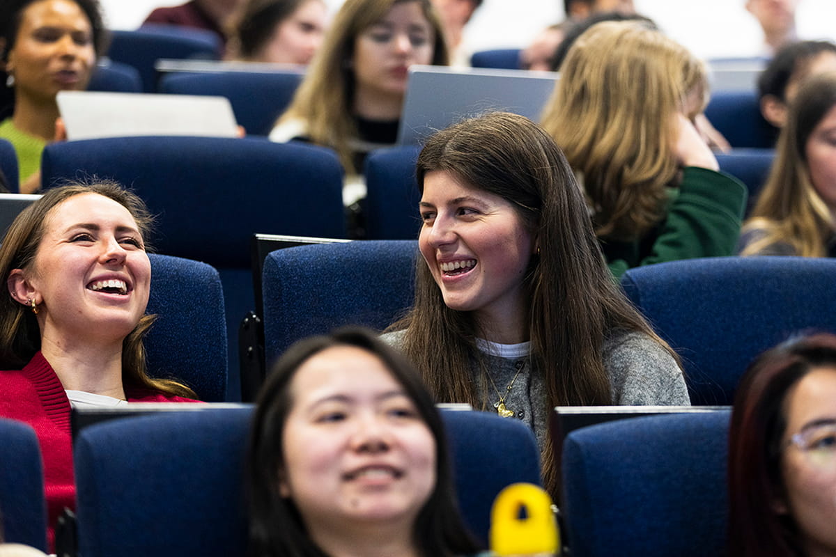 Students in a lecture theatre smiling