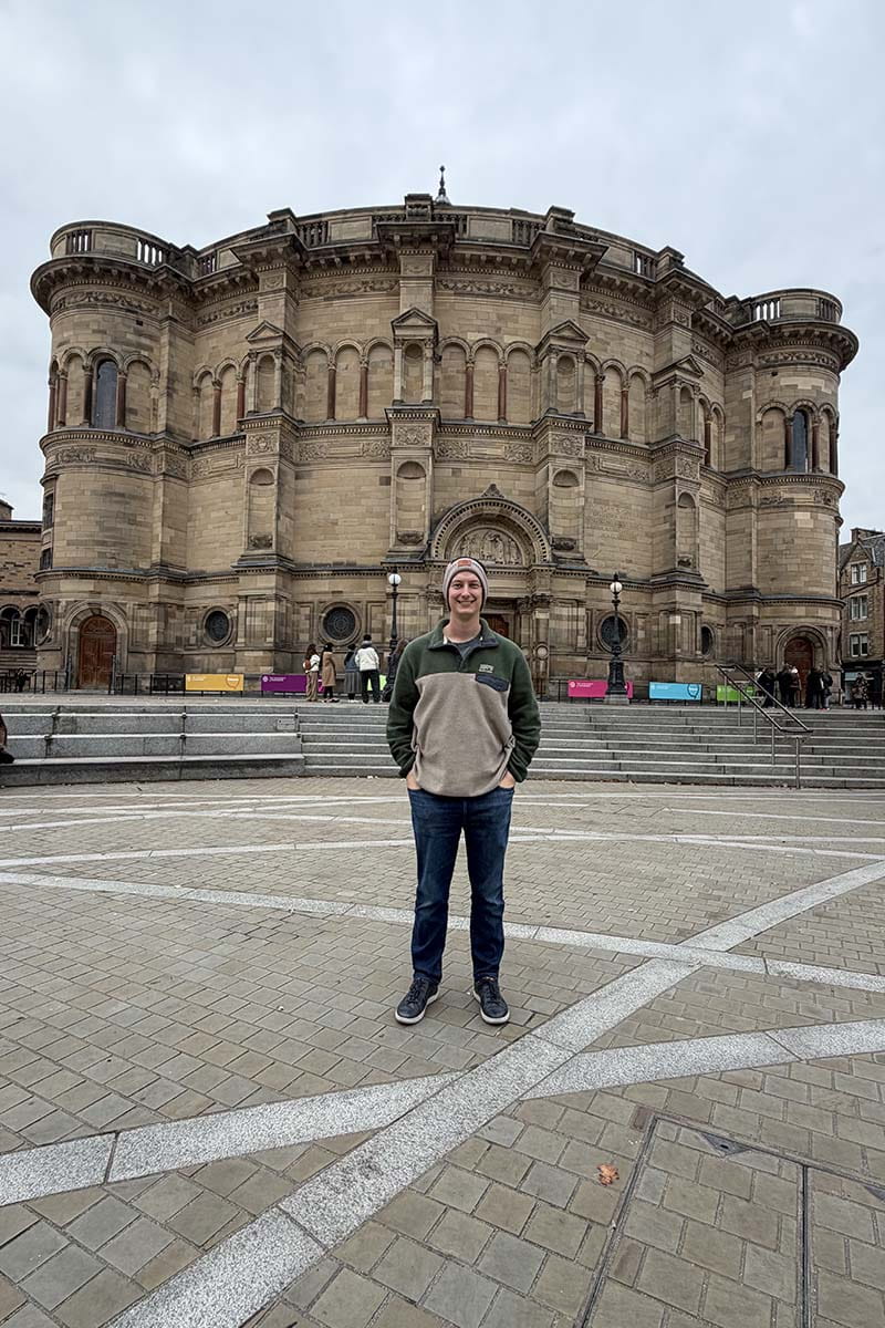 Calvin standing in front of McEwan Hall, Edinburgh