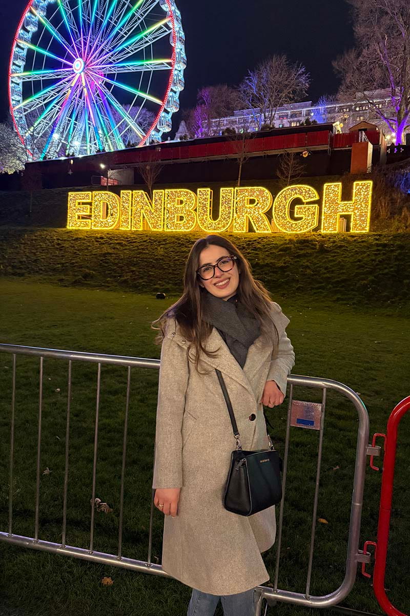 Cecilia at the Edinburgh Christmas Market in front of the big wheel 