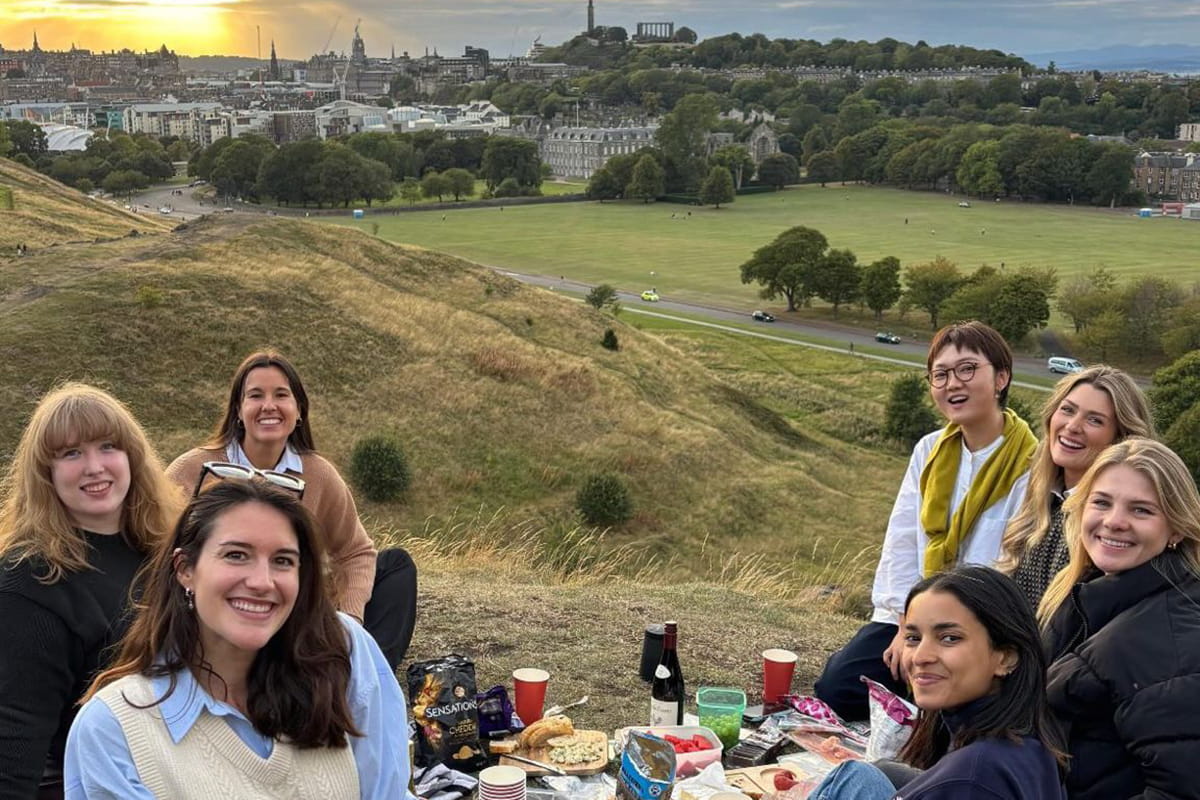 Group of students having a picnic on Arthur's Seat in Edinburgh