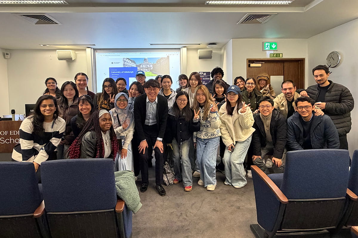 A group of MSc International Human Resource Management students from the University of Edinburgh gathered together for a group photo indoors