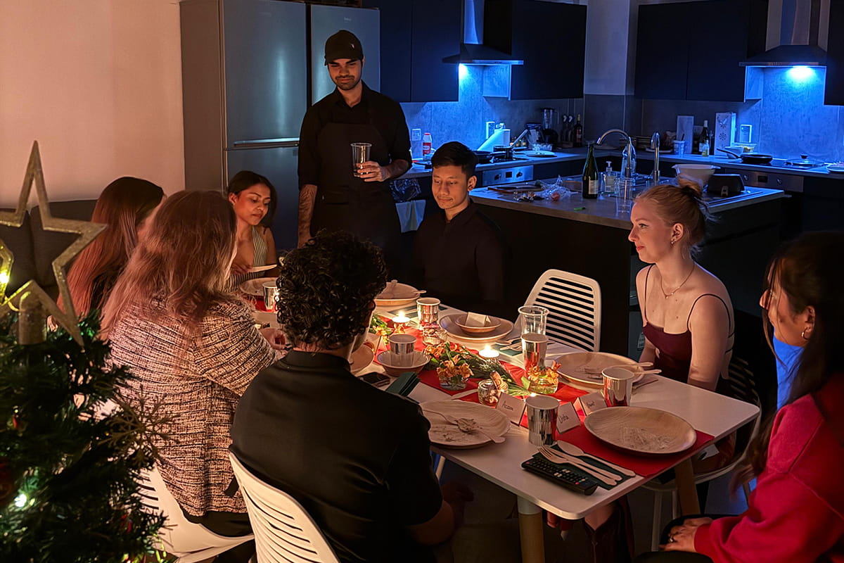 Eight students gathered around a table for a festive meal