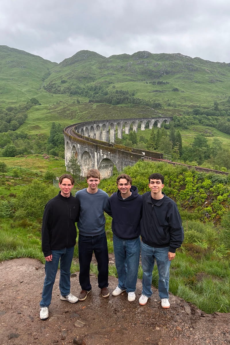 Four MSc students with the Glenfinnan viaduct in the background