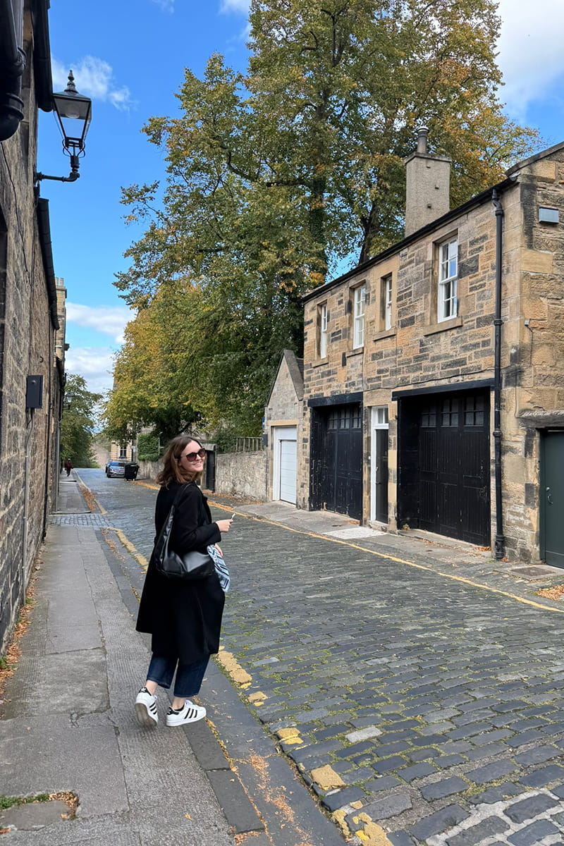 MSc student walking up a cobbled street in Edinburgh