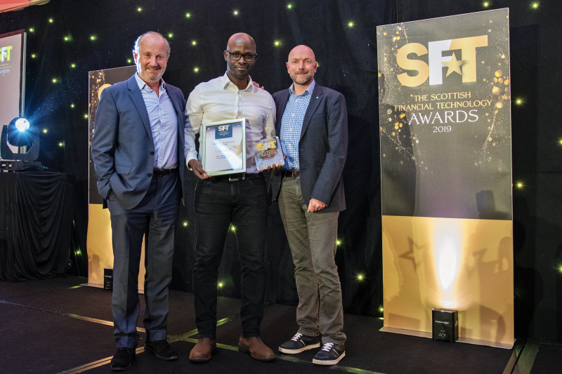 Gbenga Ibikunle collecting award at the Scottish Financial Technology Awards