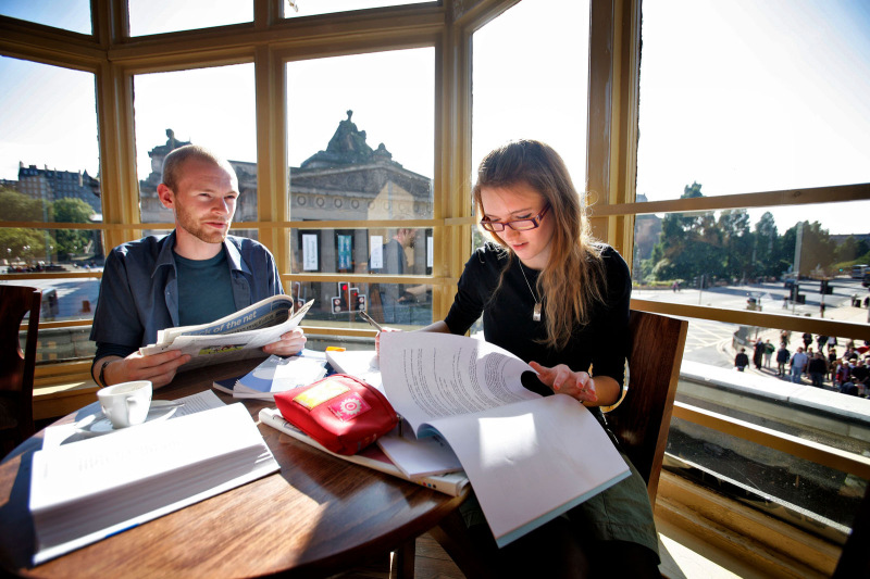 Students in cafe overlooking the National Gallery of Scotland
