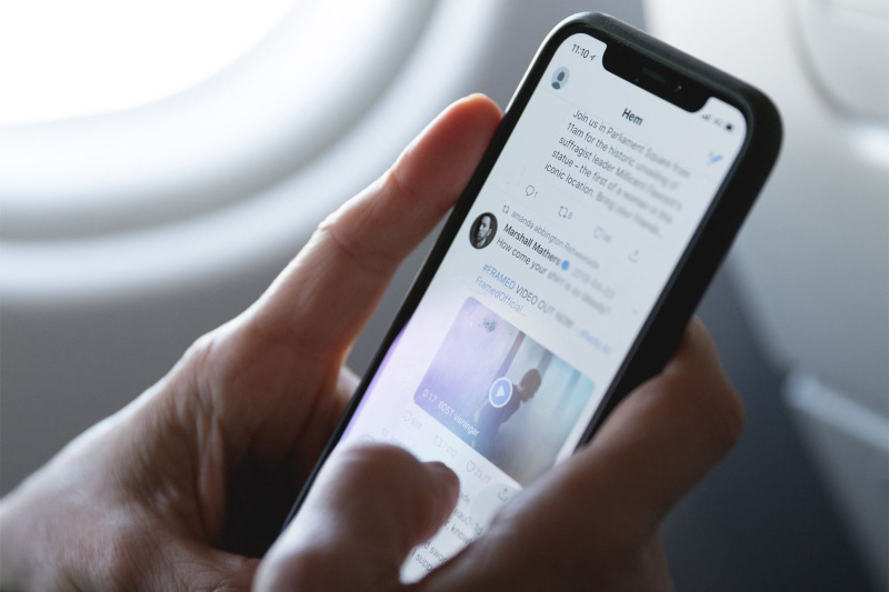 Person viewing newsfeed on a mobile phone