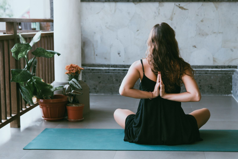 Looking after Mental Health | Woman doing yoga on balcony