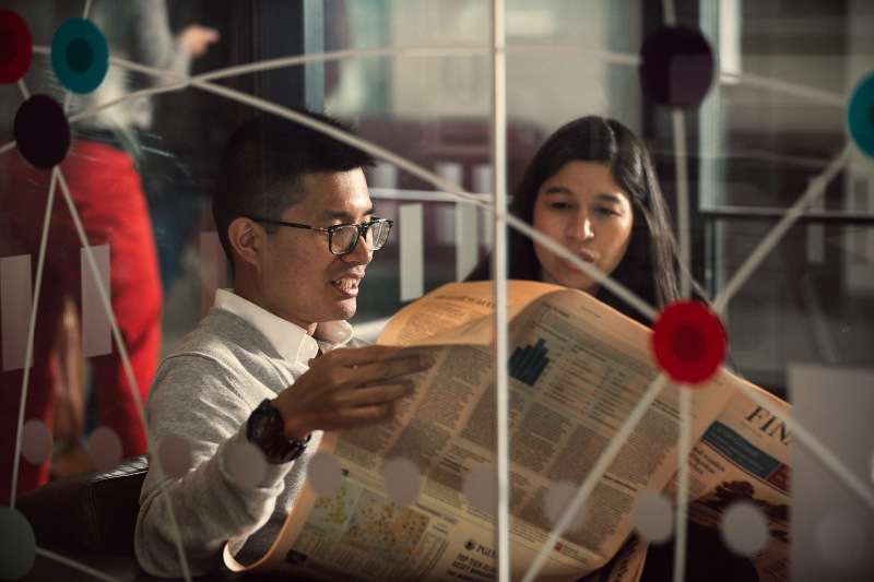 Financial trek to London - students reading Financial Times