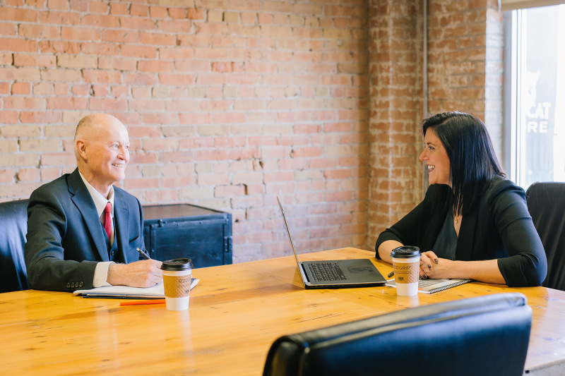man and woman talking inside an office