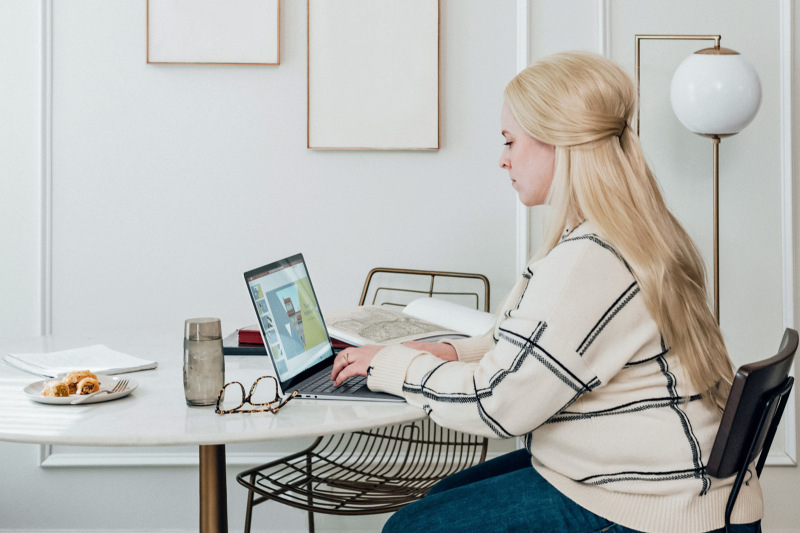 Women sitting at a table using a laptop