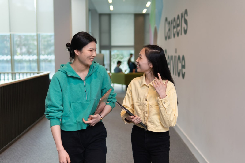 Two students talking on campus
