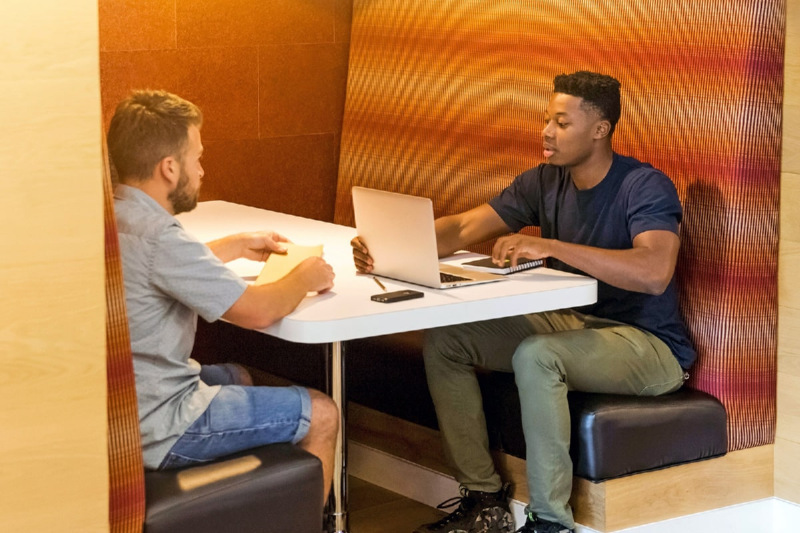Two men sitting at a desk 