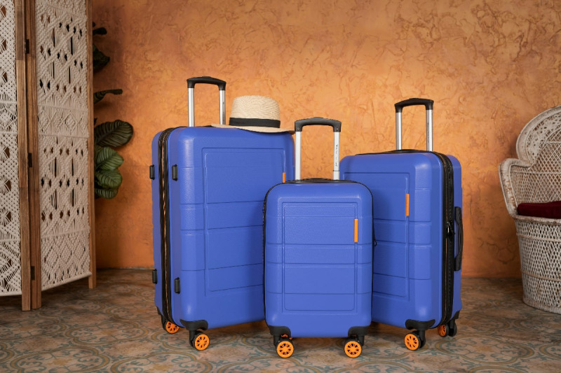 A collection of three blue suitcases lined up