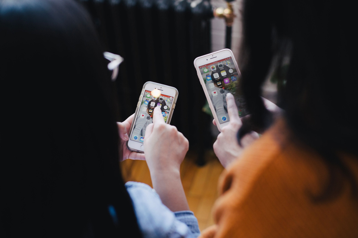 Two people using mobile phones