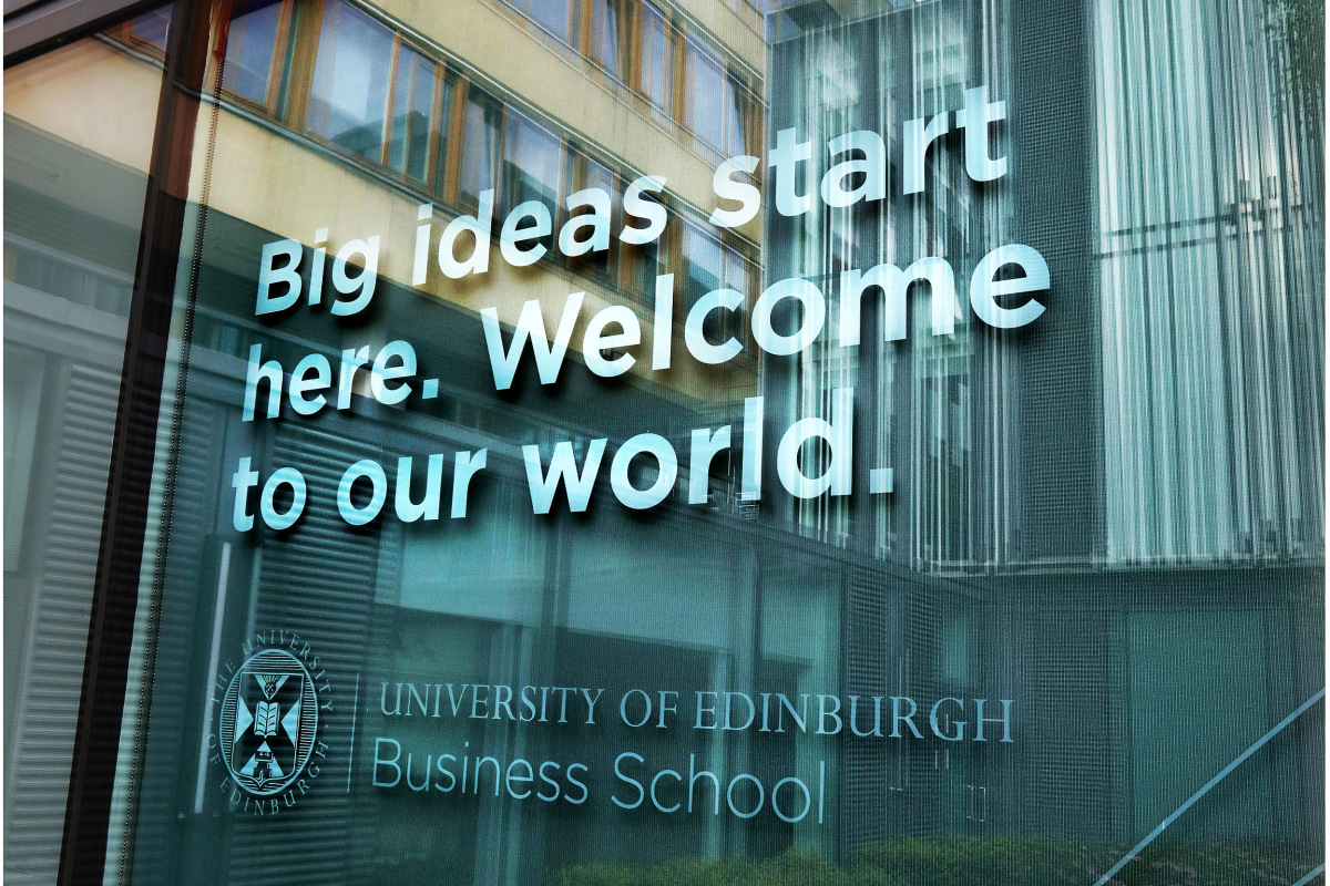 Exterior shot of the Business School with a branded quote saying: 'Big ideas start here. Welcome to our world.'