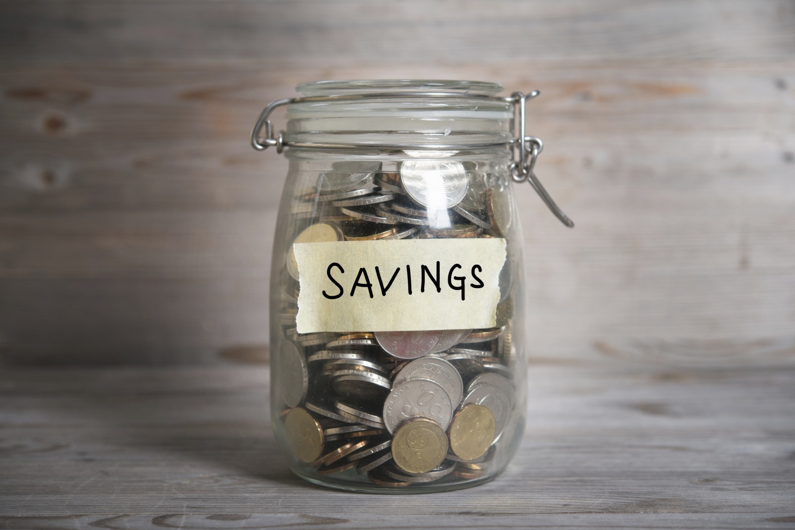 Money jar with savings label.