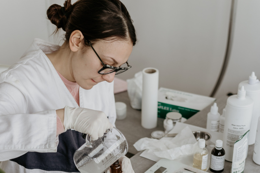 Female scientist using a beaker