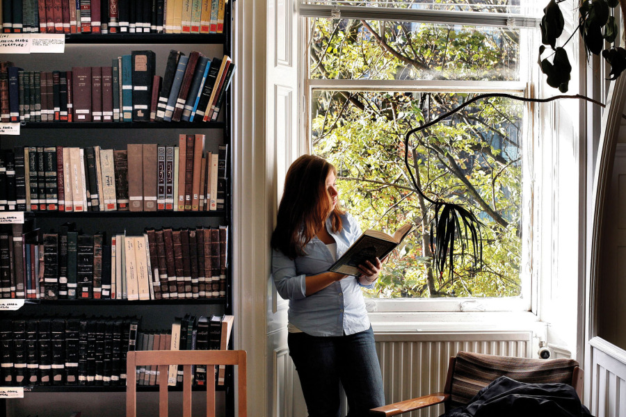 Woman reading in office by a window