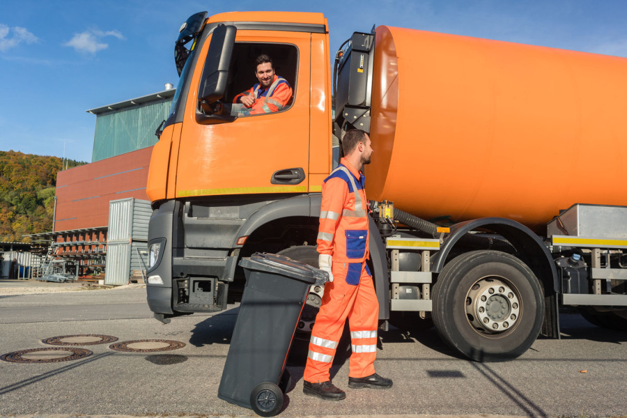 Two garbage truck public service employees