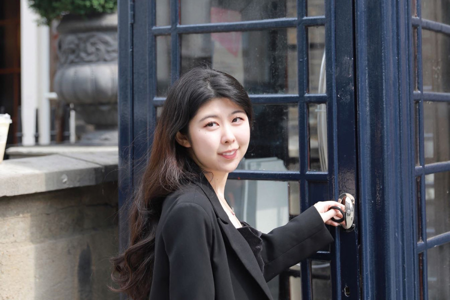 Jingyuan Chen outside a blue telephone box