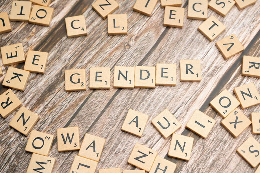 Scrabble tiles spelling the word 'gender'. Photo by Markus Winkler, unsplash