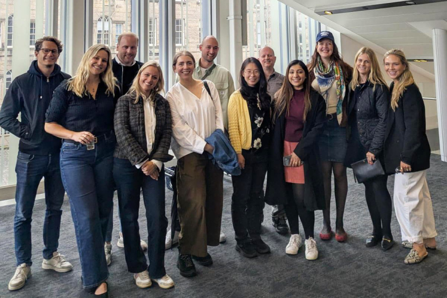 Group of alumni standing inside the University of Edinburgh Business School